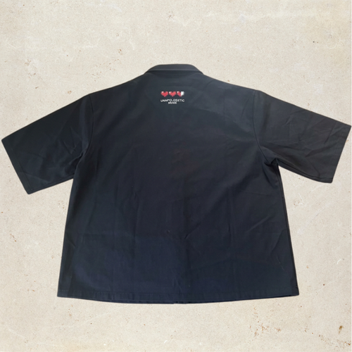 Black button up shirt with heart patch and logo on the back