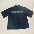 Black button up shirt with white text